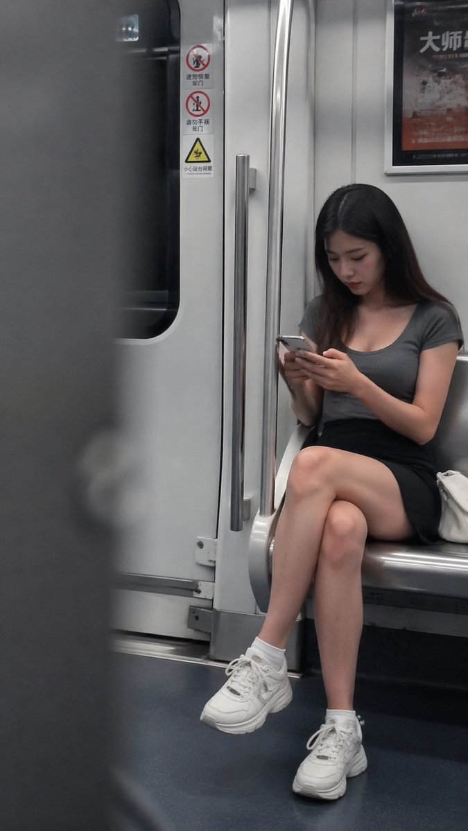 Candid Subway Snapshot of Girl on Phone — Sora 2 Prompt