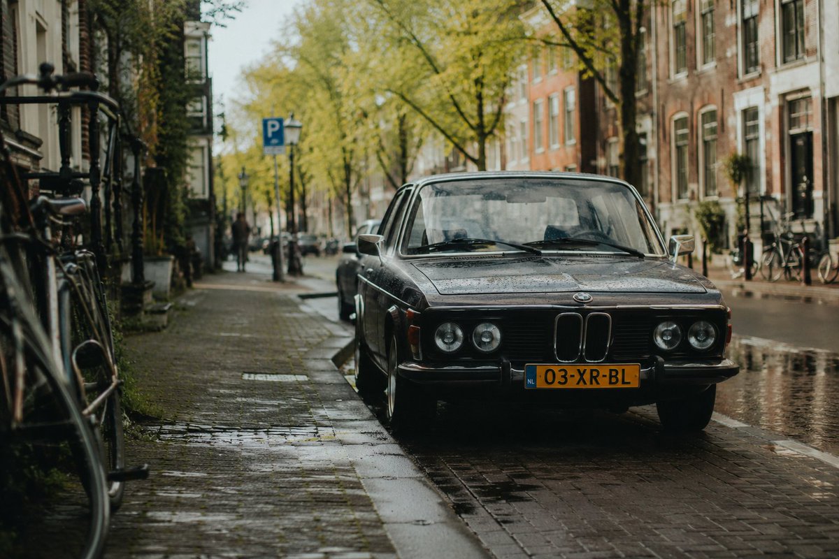 Vintage BMW in Rainy Dutch Street — Cinematic Film Prompt